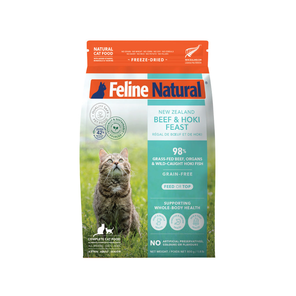 Feline Natural Freeze Dried Beef & Hoki cat food bag with a tabby cat, green grass, and product details.