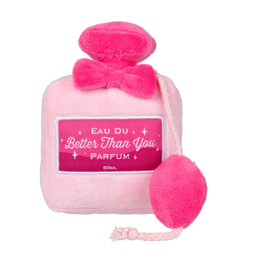Pink plush dog toy shaped like a vintage perfume bottle with "Better Than You Parfum" label and hot pink trim.