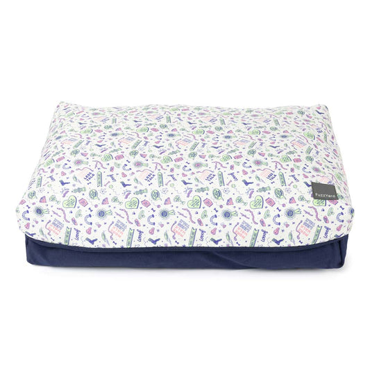 FuzzYard Big Dreamer Pillow Dog Bed in Best In Show, a rectangular white pillow with colorful dog-themed doodles and a navy base.