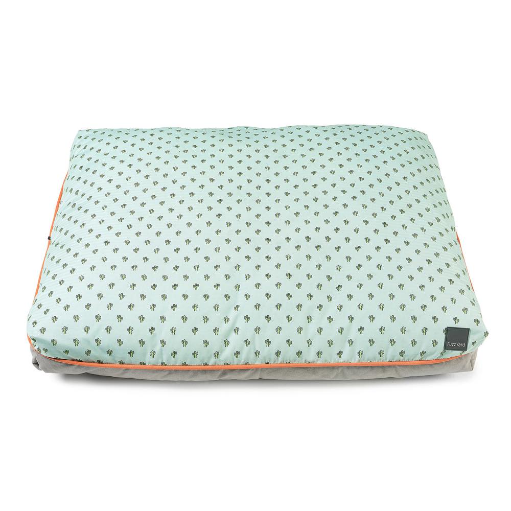 FuzzYard Big Dreamer Pillow Dog Bed (Tucson) with light green cactus print, orange piping, and grey base.