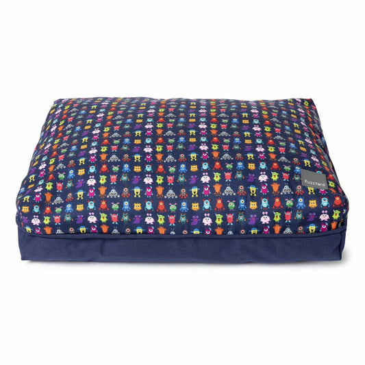 FuzzYard Big Dreamer Pillow Dog Bed in Yardsters design, a navy blue bed with colorful monster print.