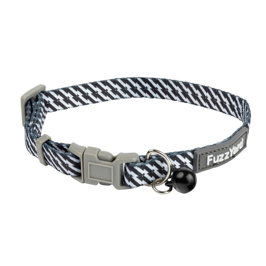 FuzzYard Tabbytooth black/white cat collar with diagonal stripes, grey break-away buckle, bell, and FuzzYard tag.