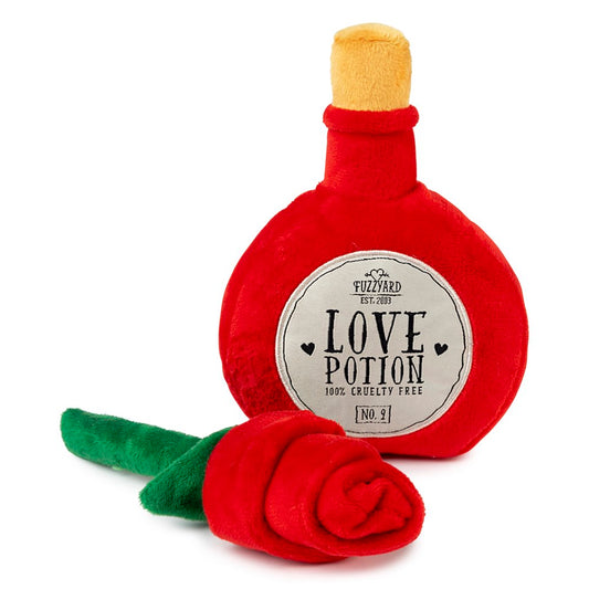 Red plush "Love Potion" bottle dog toy with a yellow cork and a red plush rose with a green stem.