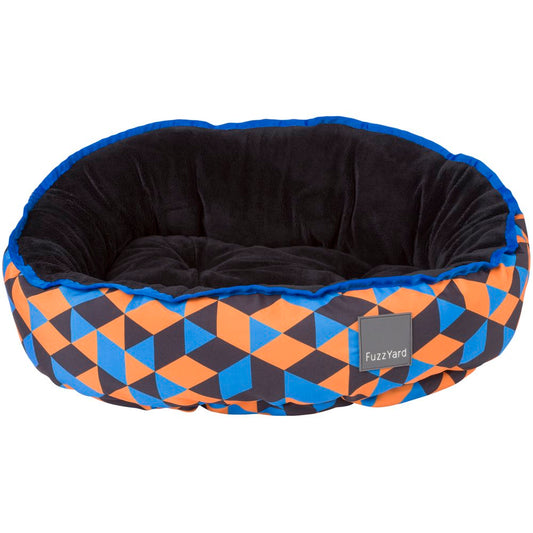 FuzzYard Reversible Dog Bed (Amsterdam) with vibrant orange, blue, and black geometric print, plush black interior.
