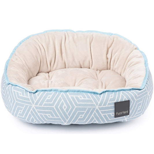 FuzzYard Reversible Dog Bed in light blue geometric pattern with a soft, cream-colored plush interior.