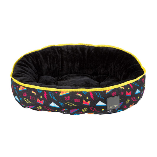 FuzzYard Reversible Dog Bed (Bel Air) with black plush interior and vibrant 80s geometric print exterior.