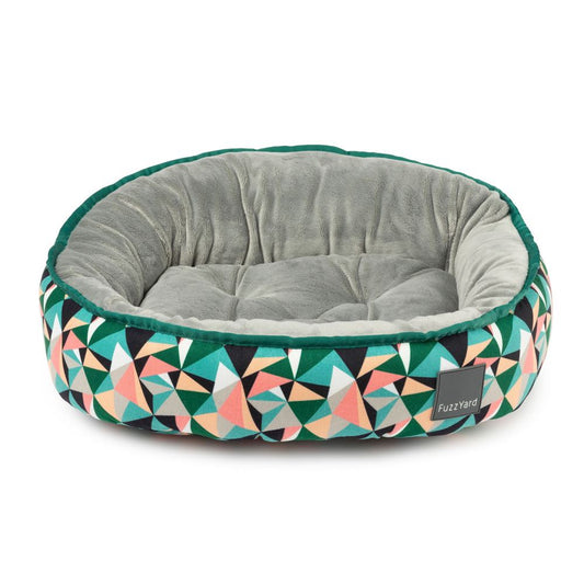 FuzzYard Reversible Dog Bed in Biscayne, featuring a geometric print with green, pink, and black triangles, and a soft grey interior.