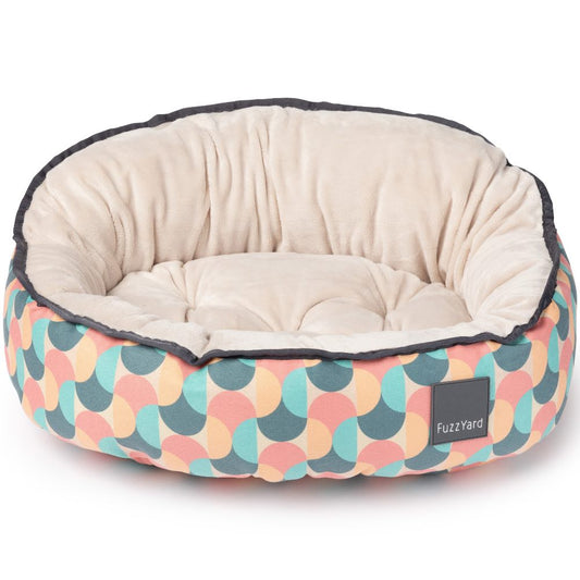 FuzzYard Reversible Dog Bed (Carioca) with a colorful geometric pattern and soft cream interior.