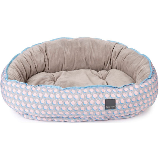 FuzzYard Reversible Dog Bed (Dippin') with pastel pink polka dots, blue trim, and a velvety plush interior.