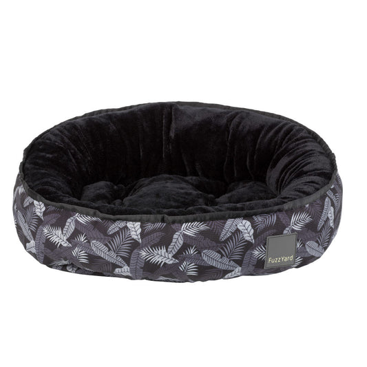FuzzYard Reversible Dog Bed (Kapalua) with dark tropical leaf print exterior and plush black interior.