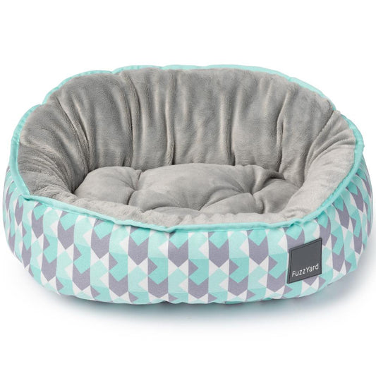FuzzYard Reversible Dog Bed in Mint Fizz with a gray plush interior and geometric mint, gray, and white pattern.