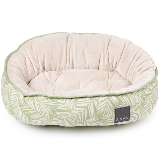 FuzzYard Reversible Dog Bed in Palmetto design, featuring green palm leaves on cream fabric with a plush beige interior.
