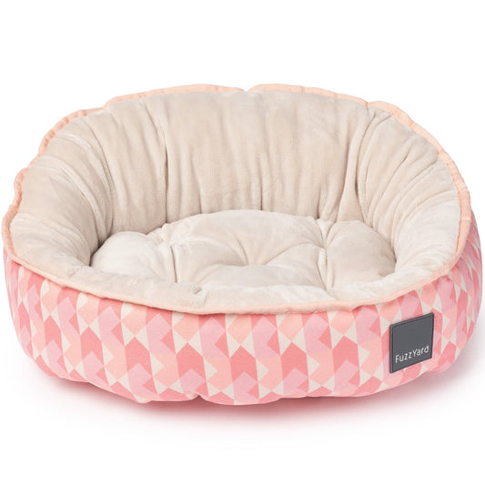 FuzzYard Reversible Dog Bed in Pink Lemonade, featuring a soft pink geometric pattern and plush cream interior.