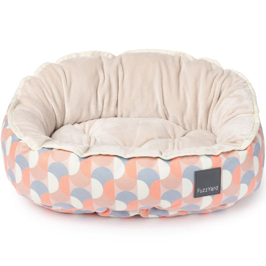 FuzzYard Reversible Dog Bed (Ravenna) with a peach, blue, and white geometric pattern and soft beige interior.