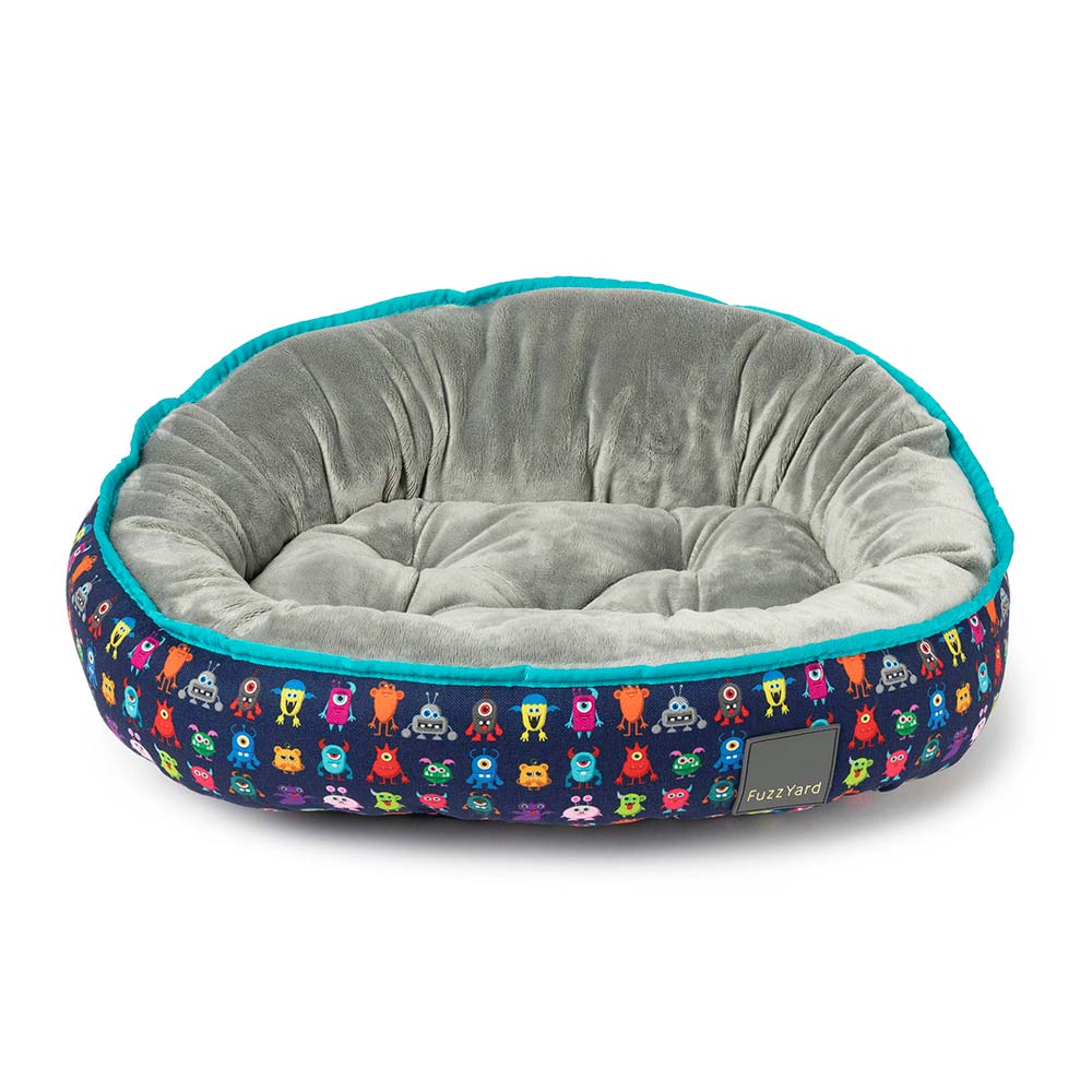 FuzzYard Reversible Dog Bed in Yardsters with colorful monster print and soft gray interior.