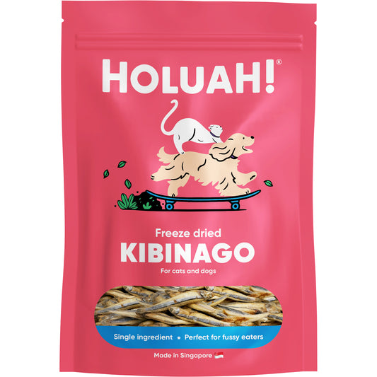 Pink Holuah! freeze-dried Kibinago cat & dog treats pouch with a clear window showing whole silver-striped herring.