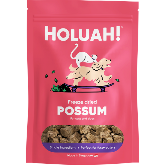 Holuah! 50g freeze-dried possum pet treats in a pink pouch with a dog and cat graphic.