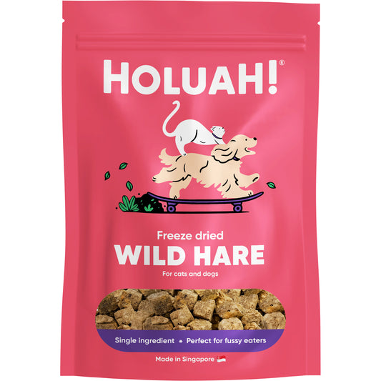 Pink pouch of Holuah! Freeze Dried Wild Hare treats for cats and dogs, showing brown meat chunks.