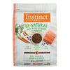 Instinct Be Natural Salmon & Brown Rice dry dog food bag with salmon, kibble, carrots, and fruit.