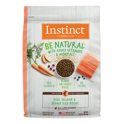 Instinct Be Natural Salmon & Brown Rice dry dog food bag with salmon, kibble, carrots, and fruit.