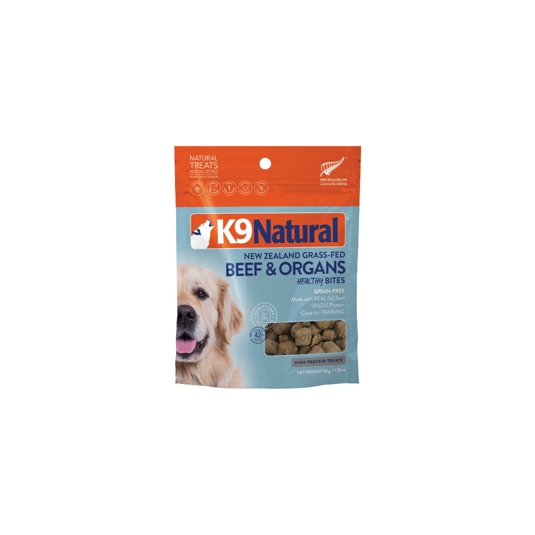 K9 Natural Healthy Bites dog treats, beef & organs flavor, in a white and blue pouch with a golden retriever.