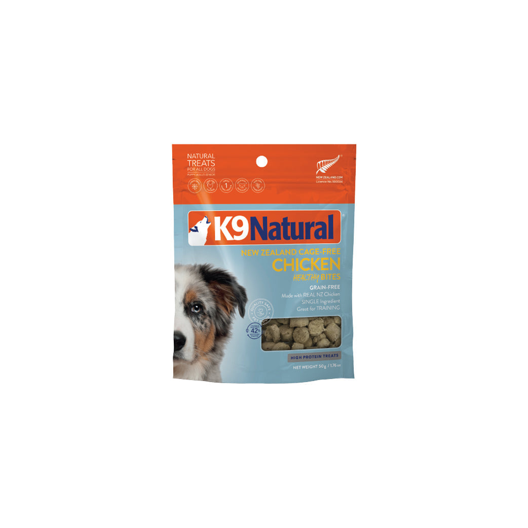 K9 Natural Healthy Bites chicken dog treats in a light blue and orange pouch with a dog's face.