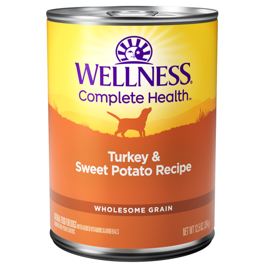 Wellness Complete Health Turkey & Sweet Potato wet dog food, 12.5oz can with orange and yellow label.