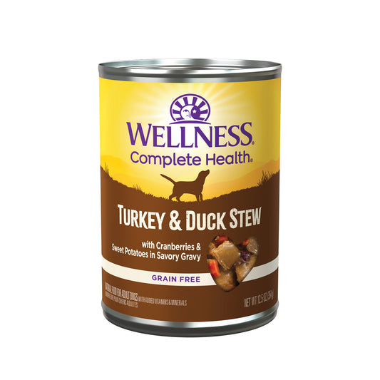 Wellness Complete Health Turkey & Duck Stew wet dog food can, 12.5oz, with a heart-shaped food sample.