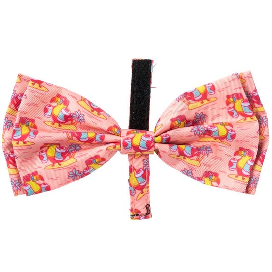 Pink polyester FuzzYard pet bowtie with a quirky toucan and surfboard print, featuring a black velcro loop.
