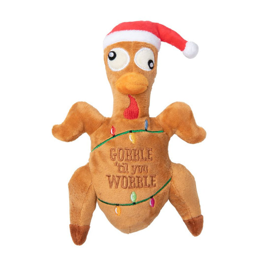 Plush brown turkey dog toy wearing a red Santa hat, wrapped in colorful Christmas lights, with "Gobble 'til you Wobble" embroidered.