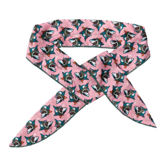 Pink FuzzYard pet cooling bandana with a repeating shark pattern and green stitching.