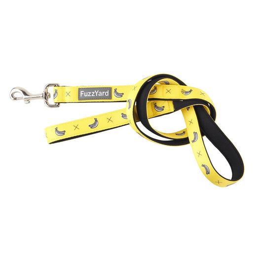 Yellow FuzzYard dog leash with banana print, black padded handle, and silver steel clasp.