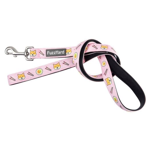 Pink FuzzYard dog leash with cute cartoon Shibas, sushi, and ramen, featuring a black padded handle and silver clasp.