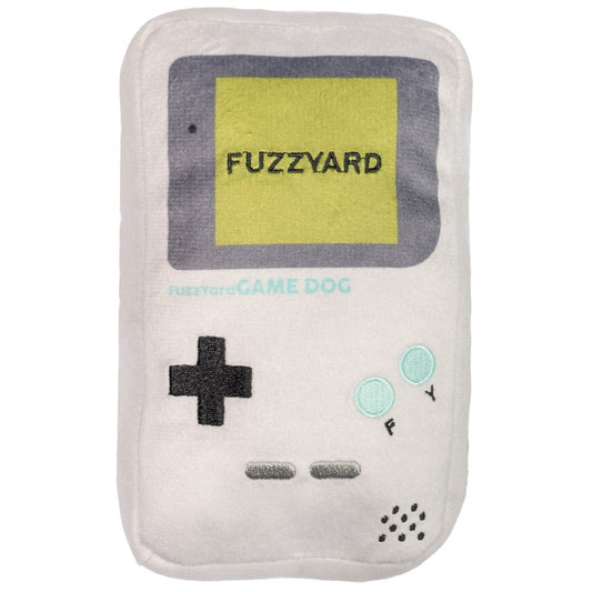 White plush dog toy shaped like a retro handheld game console with "FUZZYARD" on the screen.