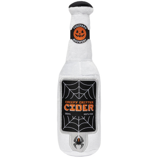 White plush dog toy shaped like a cider bottle with a Halloween spiderweb and pumpkin label.