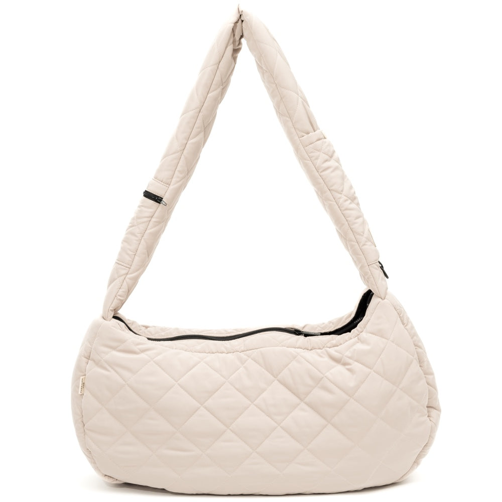 FuzzYard Life quilted sandstone dog carrier with padded strap and black zipper.