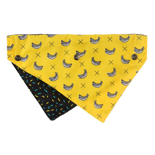 Reversible FuzzYard Pet Bandana in yellow with banana print and black with colorful sprinkles.