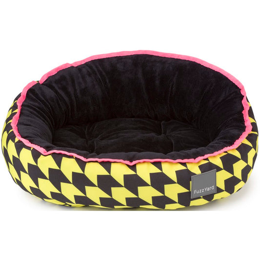FuzzYard Reversible Dog Bed (Harlem) with black plush interior, yellow & black geometric pattern, and pink trim.